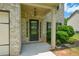 Elegant front entrance with a classic black door, sidelights, and manicured landscaping at 917 Revere Way, Hampton, GA 30228