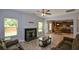 Cozy living room with a fireplace, wood-look floors, and an open view to the kitchen at 917 Revere Way, Hampton, GA 30228