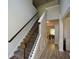 View of staircase with wood and iron railing and hardwood floors leading to the second floor of the house at 917 Revere Way, Hampton, GA 30228