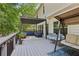 Spacious back deck featuring an outdoor kitchen, pergola with seating, and porch swing, perfect for entertaining at 135 Clubhouse Nw Dr, Kennesaw, GA 30144