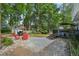Private backyard with deck, a stone fire pit area, storage shed, and mature trees for shade and tranquility at 135 Clubhouse Nw Dr, Kennesaw, GA 30144