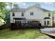 The backyard of the home is landscaped with a deck, fire pit area, and spacious lawn at 135 Clubhouse Nw Dr, Kennesaw, GA 30144