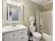 Cozy bathroom featuring a vanity, toilet, and bathtub with shower, perfect for relaxation at 135 Clubhouse Nw Dr, Kennesaw, GA 30144