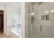 Renovated bathroom highlighting frameless glass shower, soaking tub, and walk-in closet at 135 Clubhouse Nw Dr, Kennesaw, GA 30144