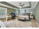 Relaxing main bedroom featuring a tray ceiling, statement wall, and comfortable furniture at 135 Clubhouse Nw Dr, Kennesaw, GA 30144