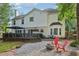 Exterior of the home featuring a deck, fire pit area, and lush landscaping in the backyard at 135 Clubhouse Nw Dr, Kennesaw, GA 30144