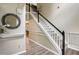 Foyer with staircase featuring hardwood floors, decorative mirror, and white and black trim at 135 Clubhouse Nw Dr, Kennesaw, GA 30144