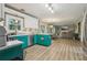 Open-concept kitchen featuring hardwood floors, stainless steel appliances, and turquoise cabinets at 135 Clubhouse Nw Dr, Kennesaw, GA 30144