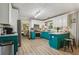 Bright eat-in kitchen with stainless appliances, teal cabinets, and light hardwood flooring at 135 Clubhouse Nw Dr, Kennesaw, GA 30144