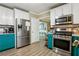 Spacious kitchen with stainless steel appliances, teal lower cabinets and white upper cabinets at 135 Clubhouse Nw Dr, Kennesaw, GA 30144