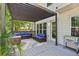 Covered outdoor patio with comfortable seating and lush greenery, perfect for entertaining or relaxing at 135 Clubhouse Nw Dr, Kennesaw, GA 30144