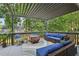 Relaxing covered outdoor patio featuring a comfortable seating area, pergola, and lush backyard at 135 Clubhouse Nw Dr, Kennesaw, GA 30144