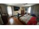Bedroom features a ceiling fan, television, hard wood floors and neutral walls at 1833 Stephenson Rd, Lithonia, GA 30058