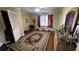 Bedroom with hardwood floor, dresser, closet, and a window with curtains at 1833 Stephenson Rd, Lithonia, GA 30058