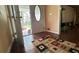 Inviting foyer with hardwood floors, a patterned rug, and natural light streaming in from the front door at 1833 Stephenson Rd, Lithonia, GA 30058