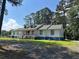 Charming single story home with a white facade, blue trim, dormer windows, and a welcoming front porch at 1833 Stephenson Rd, Lithonia, GA 30058