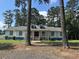 Charming single story home with a white facade, blue trim, dormer windows, and a welcoming front porch at 1833 Stephenson Rd, Lithonia, GA 30058