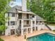 The home's exterior back is shown with a patio and pool at 550 Atlanta Country Club Se Dr, Marietta, GA 30067
