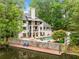 Scenic view of a luxury backyard, pool, patios, and dock on a lake at 550 Atlanta Country Club Se Dr, Marietta, GA 30067