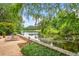 Backyard featuring a serene lake view, a stone wall, and lounge chairs for relaxation at 550 Atlanta Country Club Se Dr, Marietta, GA 30067