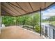 Beautiful tiled balcony with an iron railing overlooking a lush green golf course and serene lake at 550 Atlanta Country Club Se Dr, Marietta, GA 30067