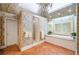 Elegant bathroom featuring tiled floors, floral wallpaper, a bathtub with jets, and a glass door shower at 550 Atlanta Country Club Se Dr, Marietta, GA 30067