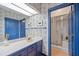Cozy bathroom featuring blue trim, a shower with a glass door, and ample counter space at 550 Atlanta Country Club Se Dr, Marietta, GA 30067