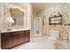 Stylish bathroom with floral wallpaper, marble countertops, dark wood cabinets, and a glass shower at 550 Atlanta Country Club Se Dr, Marietta, GA 30067