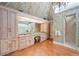 Bright bathroom with spacious vanity, elegant wallpaper, tiled floors, and a glass enclosed shower at 550 Atlanta Country Club Se Dr, Marietta, GA 30067