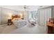 Neutral bedroom with comfortable bed, soft chaise lounge, shutters, and ceiling fan at 550 Atlanta Country Club Se Dr, Marietta, GA 30067