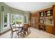 Charming breakfast nook with a large window, wood table, and built-in cabinets and desk at 550 Atlanta Country Club Se Dr, Marietta, GA 30067