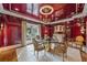 Elegant dining room featuring glossy walls, a unique chandelier, a glass table, and seating for four at 550 Atlanta Country Club Se Dr, Marietta, GA 30067