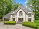 Picture of the front exterior showcasing the roof, dormer windows, entrance, and landscaping at 550 Atlanta Country Club Se Dr, Marietta, GA 30067