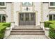 Elegant front entrance with decorative doors, stone accents, and manicured landscaping at 550 Atlanta Country Club Se Dr, Marietta, GA 30067