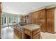 Gourmet kitchen with custom wood cabinetry, granite countertops, and a breakfast nook area at 550 Atlanta Country Club Se Dr, Marietta, GA 30067
