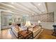 Bright living room with coffered ceiling, designer wallpaper, fireplace, and access to the outdoors at 550 Atlanta Country Club Se Dr, Marietta, GA 30067