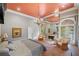 Primary bedroom suite includes fireplace, sitting area, balcony and stylish chandelier at 550 Atlanta Country Club Se Dr, Marietta, GA 30067