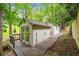 Charming outbuilding with a wooden walkway and surrounded by lush greenery at 550 Atlanta Country Club Se Dr, Marietta, GA 30067