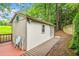 Exterior view of an outbuilding with a wooden walkway leading to its entrance at 550 Atlanta Country Club Se Dr, Marietta, GA 30067