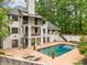 Beautiful backyard featuring a sparkling pool, patios, and lush greenery at 550 Atlanta Country Club Se Dr, Marietta, GA 30067