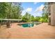 Backyard featuring a sparkling in-ground pool surrounded by a concrete patio and lush landscaping at 550 Atlanta Country Club Se Dr, Marietta, GA 30067