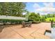 Poolside patio features an umbrella-covered table and chairs, with lush landscaping surrounding the property at 550 Atlanta Country Club Se Dr, Marietta, GA 30067