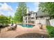 Spacious backyard with inground pool and lush landscaping adjacent to the home's back exterior at 550 Atlanta Country Club Se Dr, Marietta, GA 30067