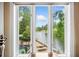 Picturesque window view overlooking a serene lake, lush greenery, a patio, and distant golf course at 550 Atlanta Country Club Se Dr, Marietta, GA 30067