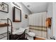 Bathroom with patterned shower curtain, vanity with dark wood mirror at 607 Lexington Way, Woodstock, GA 30189