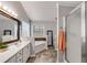 Elegant bathroom showcasing dual vanities, soaking tub, and sleek glass-enclosed shower at 607 Lexington Way, Woodstock, GA 30189