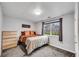 Bedroom with dresser, window, and neutral decor at 607 Lexington Way, Woodstock, GA 30189