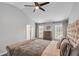 Comfortable main bedroom offering neutral colors, vaulted ceiling, fan, and bright, airy feel at 607 Lexington Way, Woodstock, GA 30189