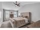Spacious main bedroom features vaulted ceiling, fan, and large bed, creating a relaxing retreat at 607 Lexington Way, Woodstock, GA 30189