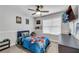 Bedroom with ceiling fan, art, flat-screen TV and themed comforter at 607 Lexington Way, Woodstock, GA 30189